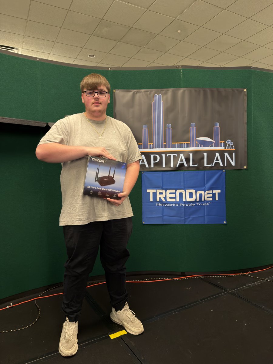 Attendee holding TRENDnet router prize