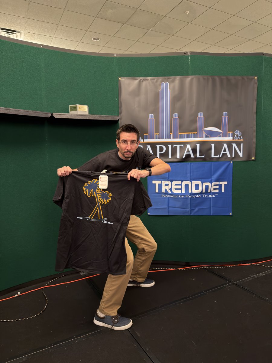 Attendee holding up a t-shirt on stage