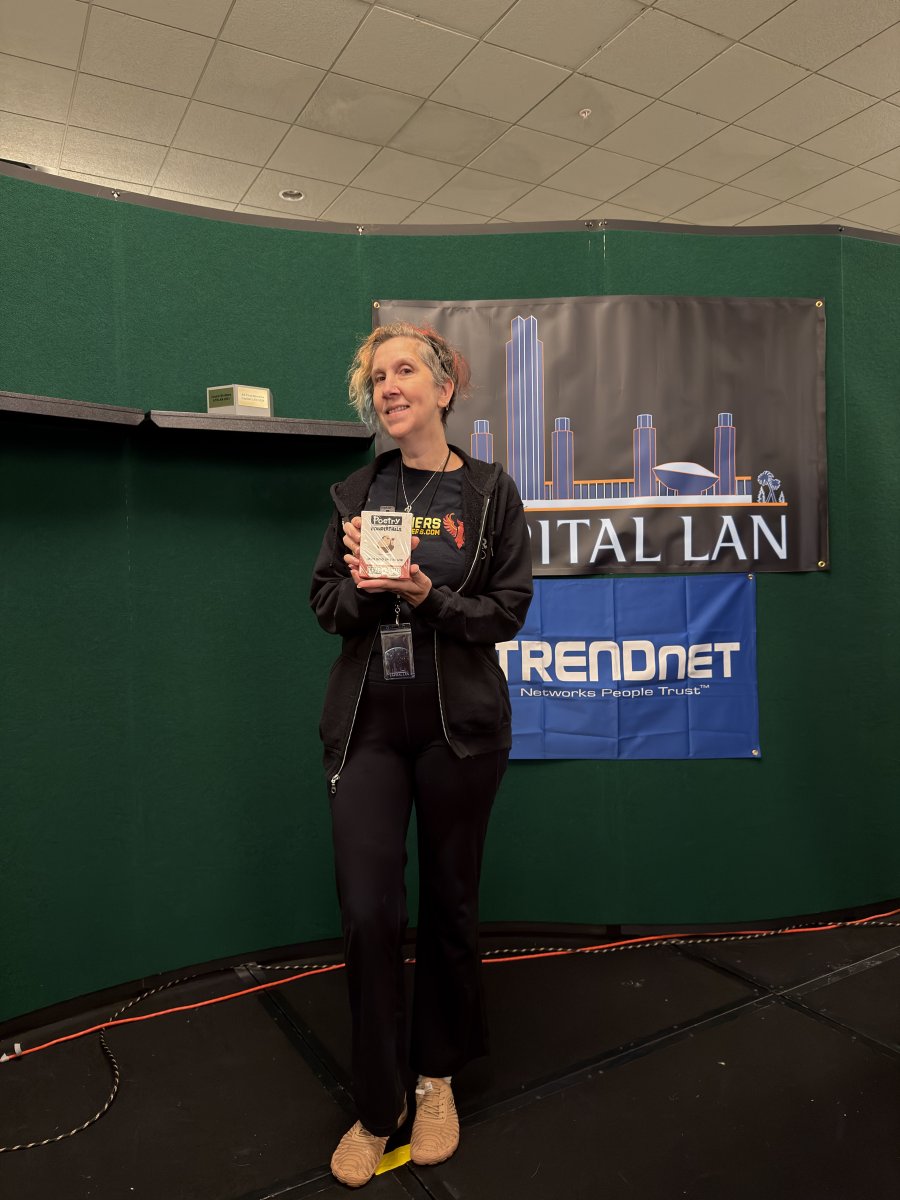 Person holding award on stage at Capital LAN