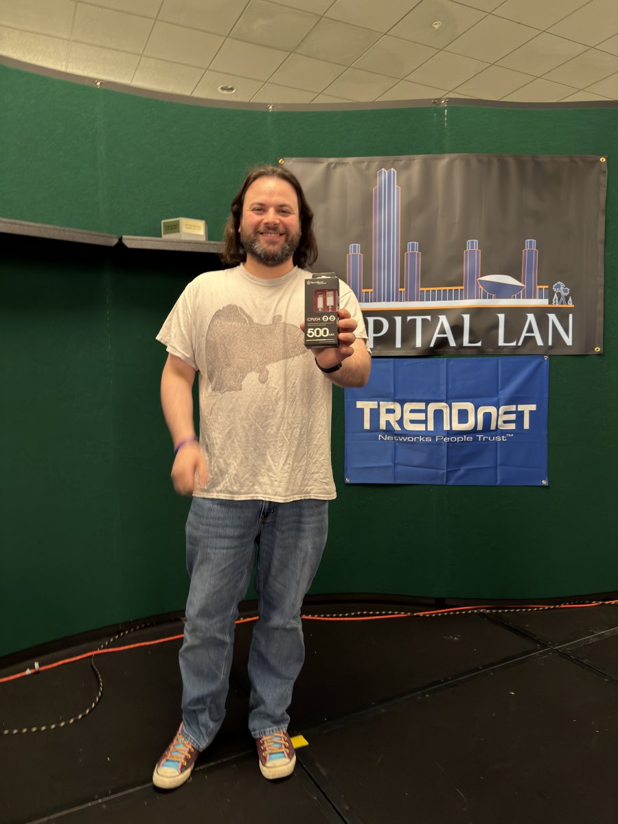 Attendee holding a prize on stage