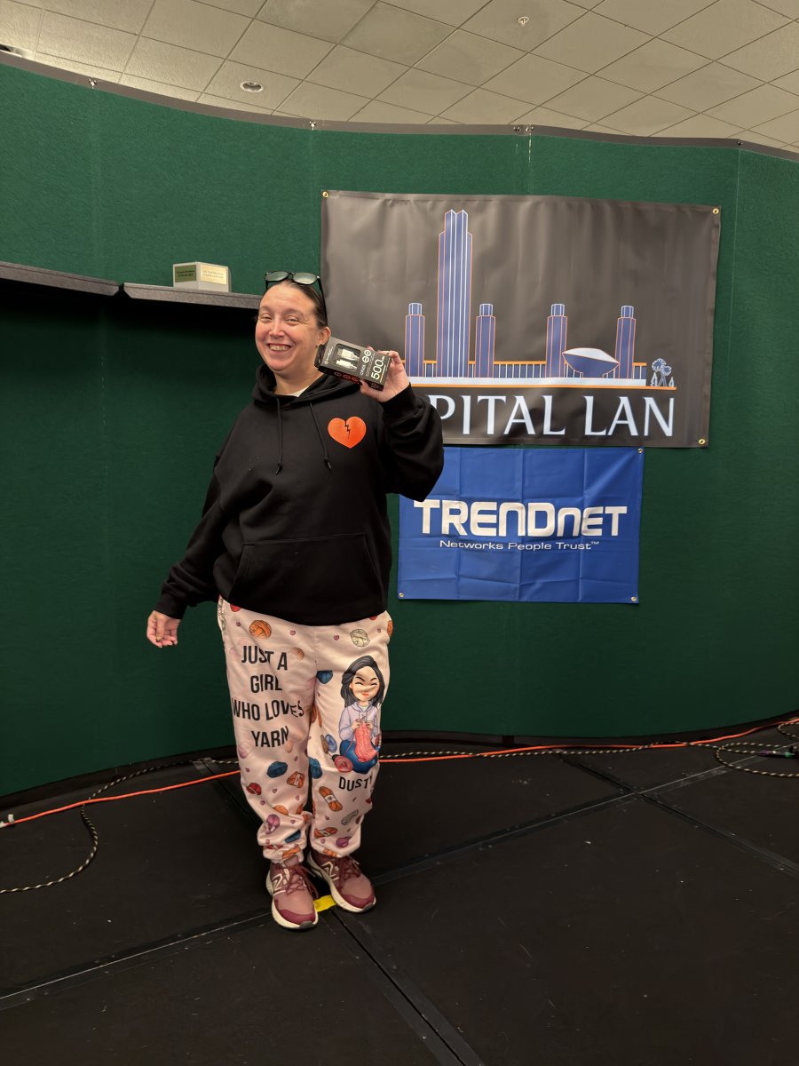 Attendee holding prize on stage