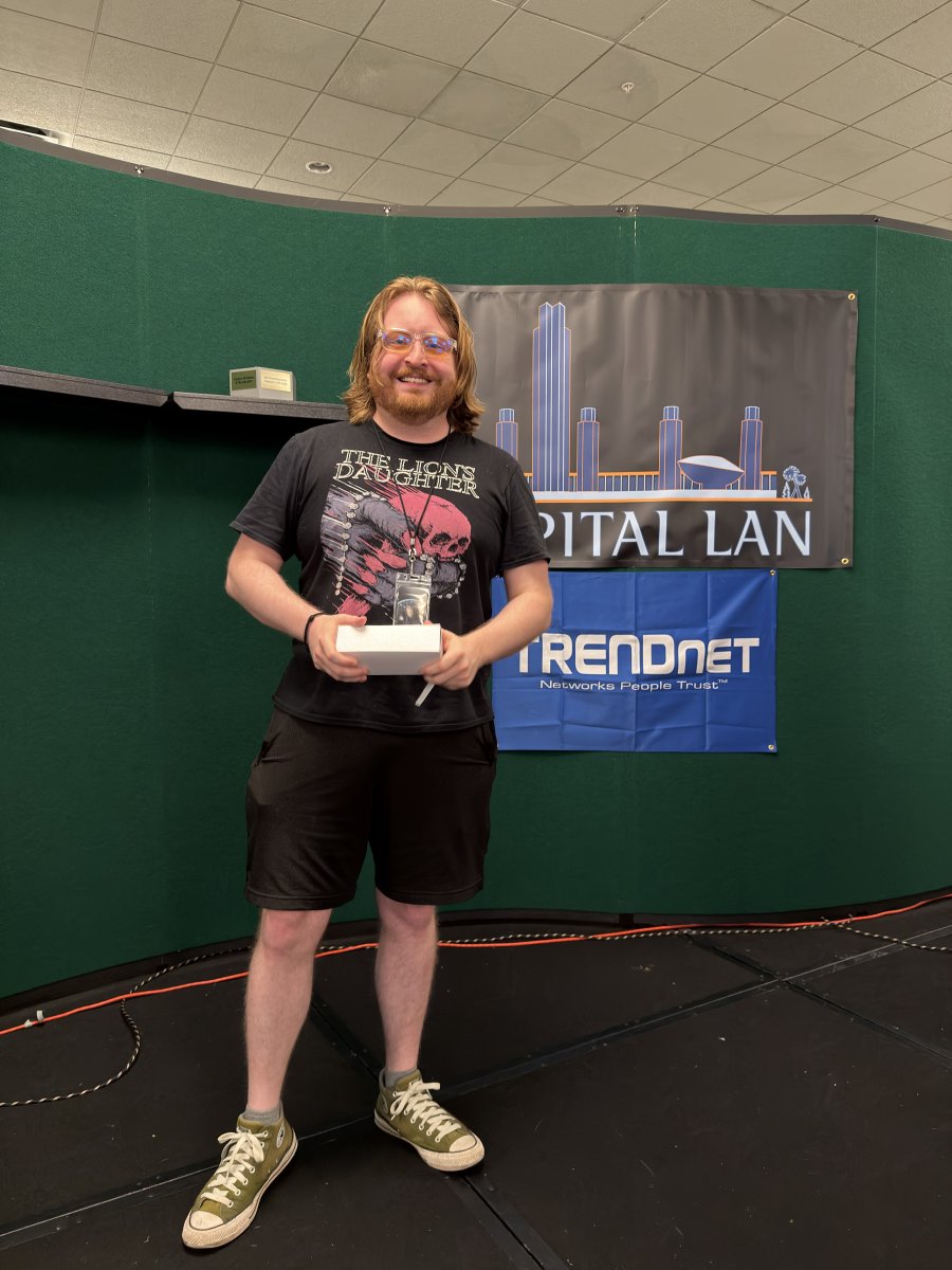Attendee holding a prize on stage