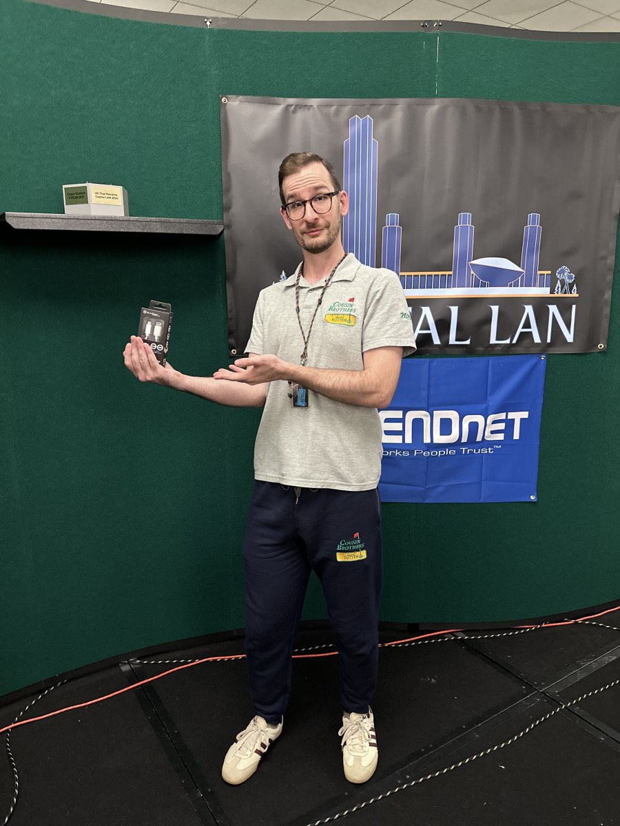 Attendee presenting a prize at Capital LAN