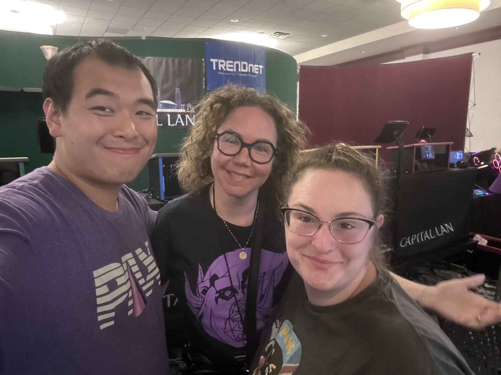 Three attendees posing for a selfie