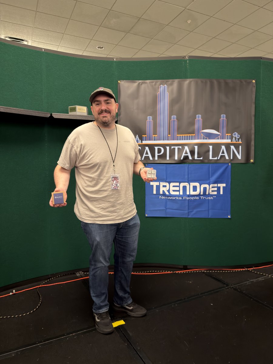 Attendee holding awards on stage