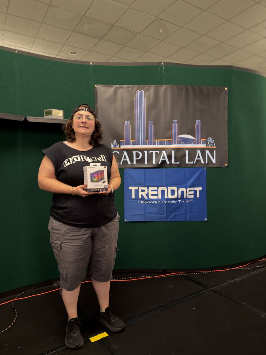 Attendee holding prize box on stage
