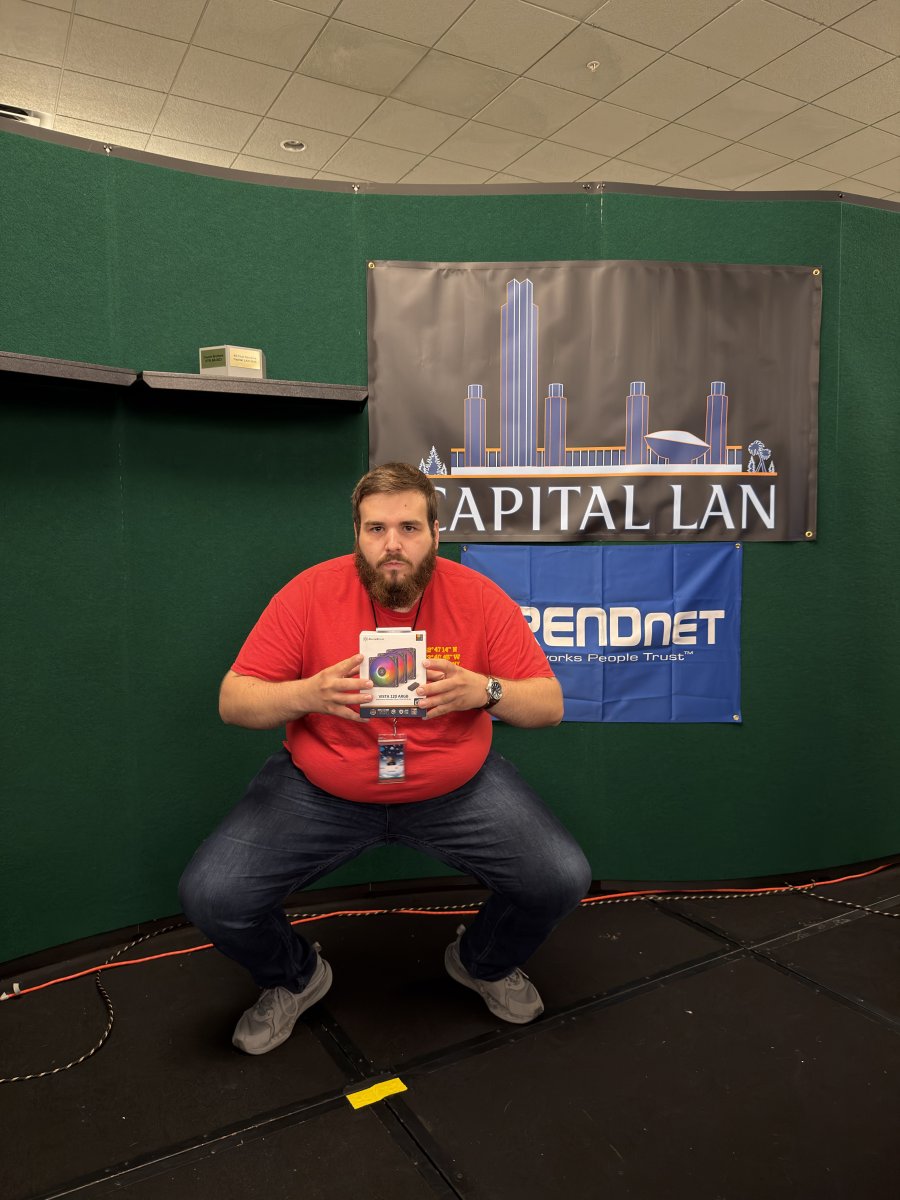 Attendee posing with a boxed computer fan