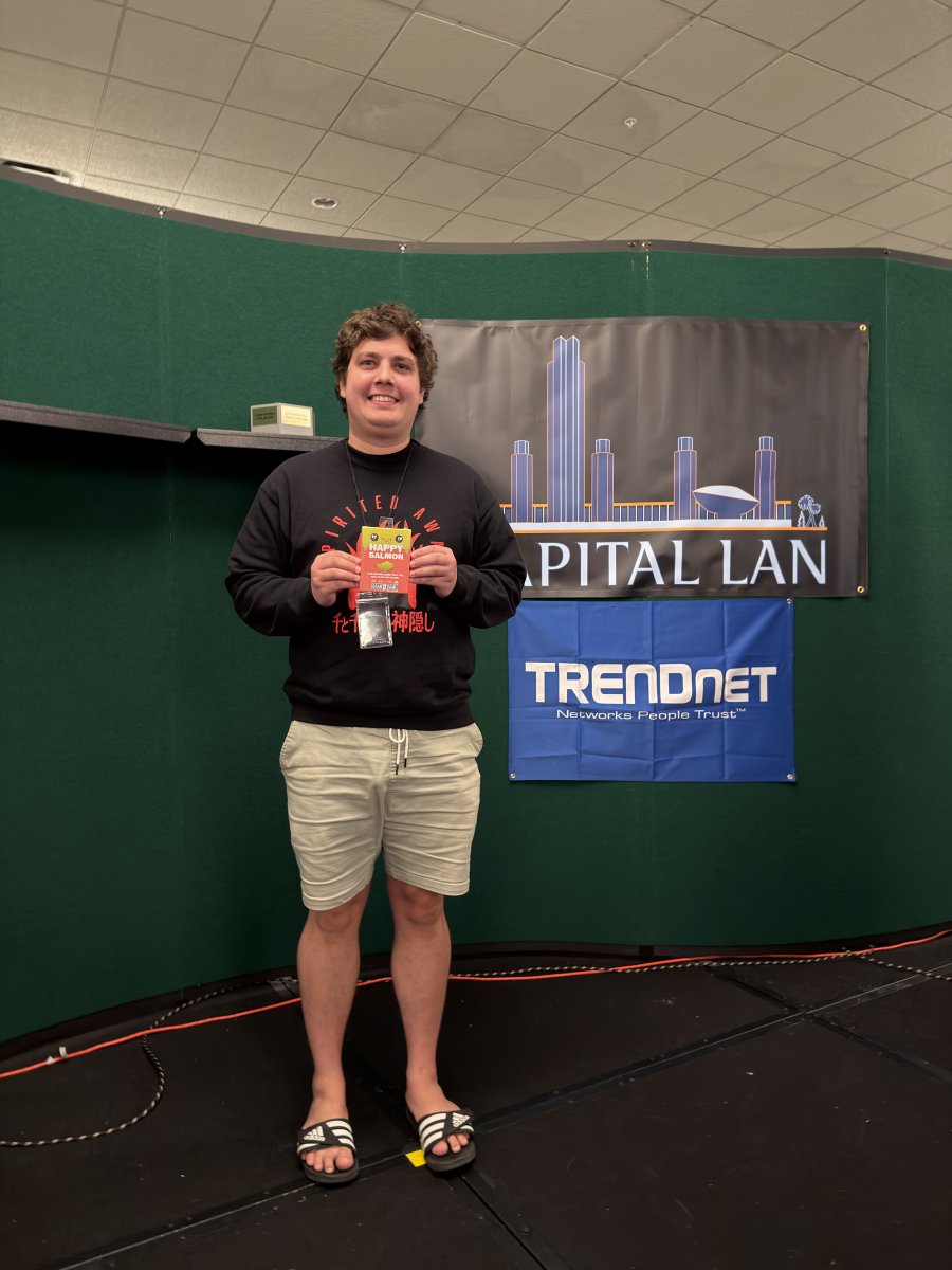 Attendee holding a prize card on stage