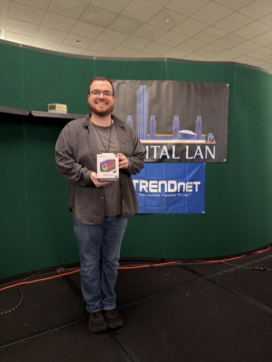 Attendee holding a boxed computer fan prize