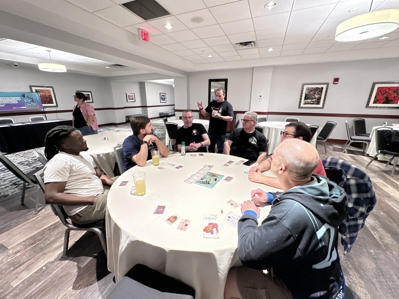 Group playing a card game at a round table