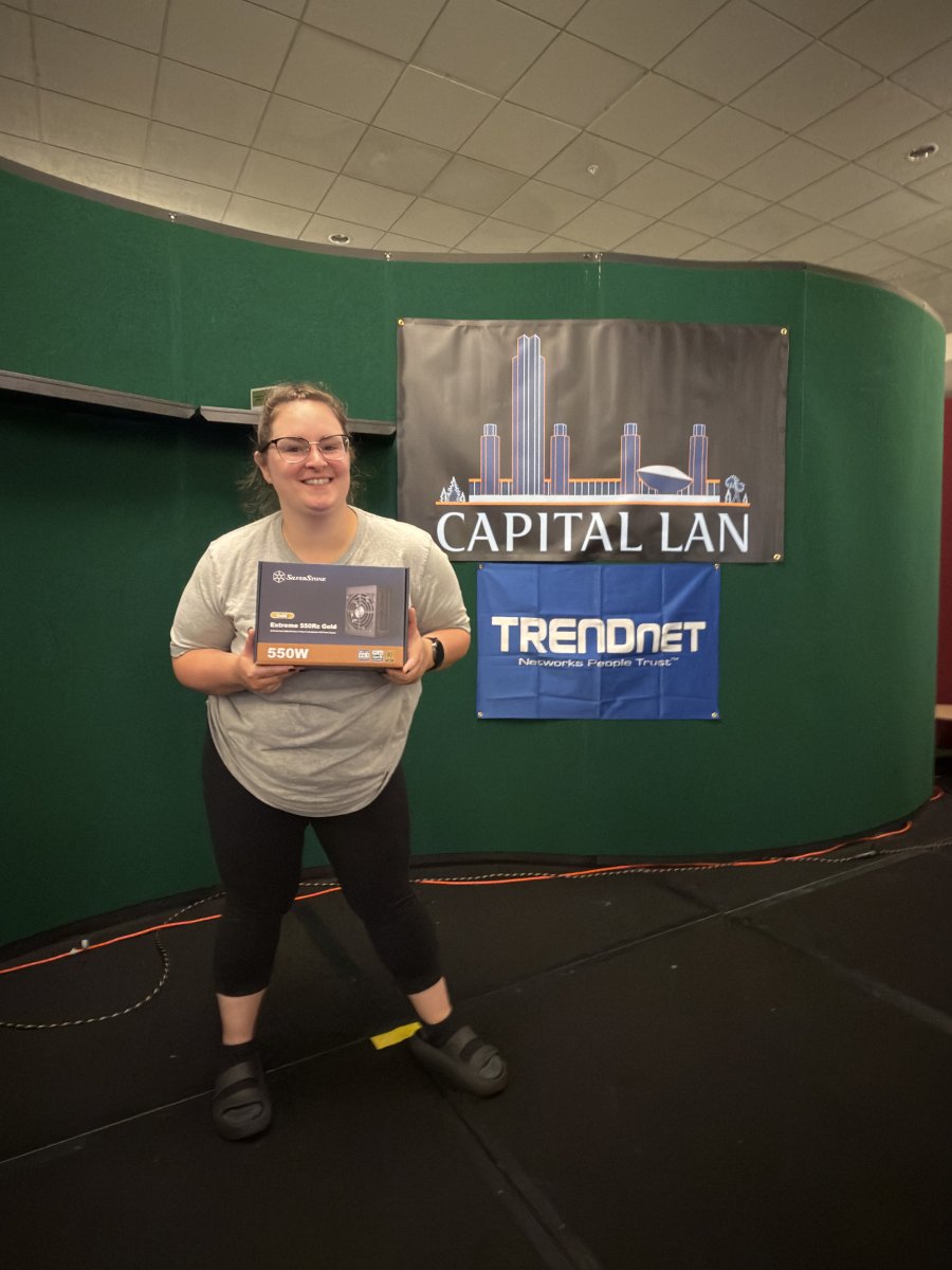 Attendee holding a computer power supply prize
