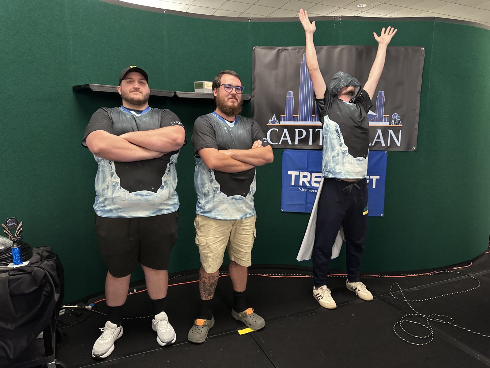 Group of three attendees posing in matching shirts