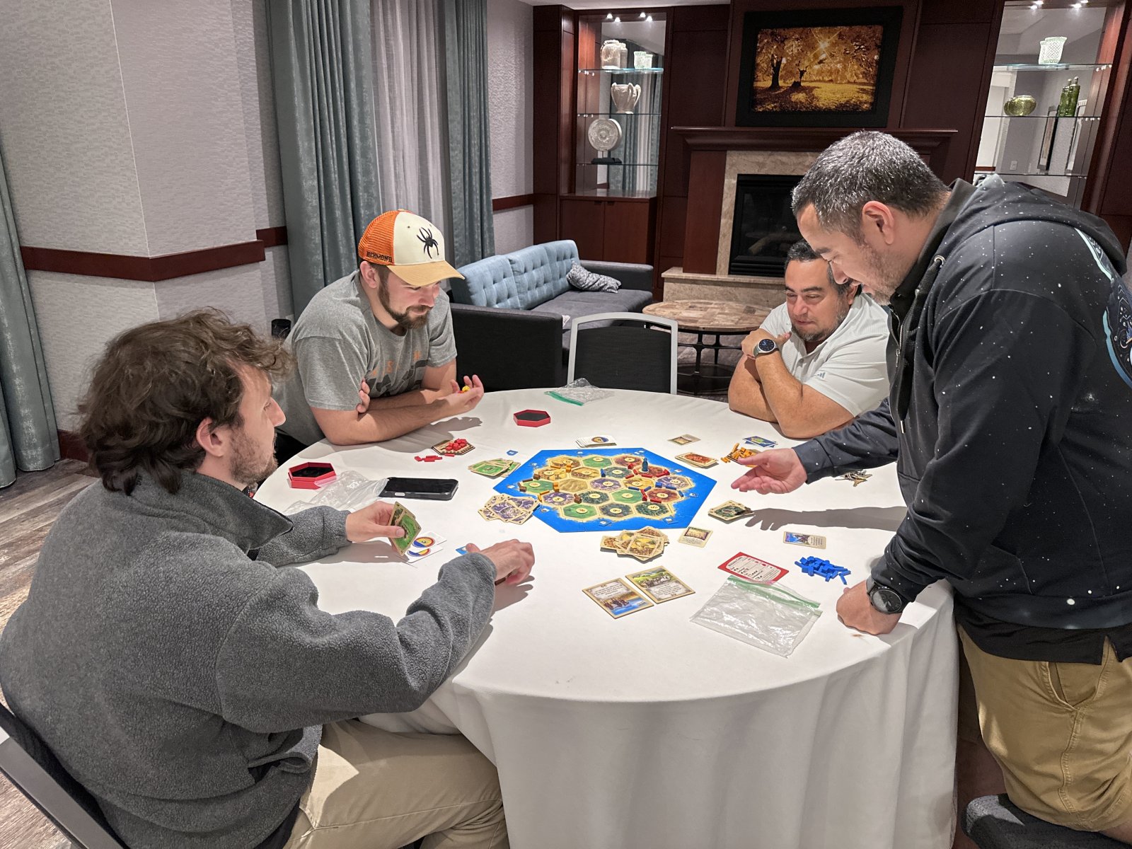 Group playing Settlers of Catan at round table