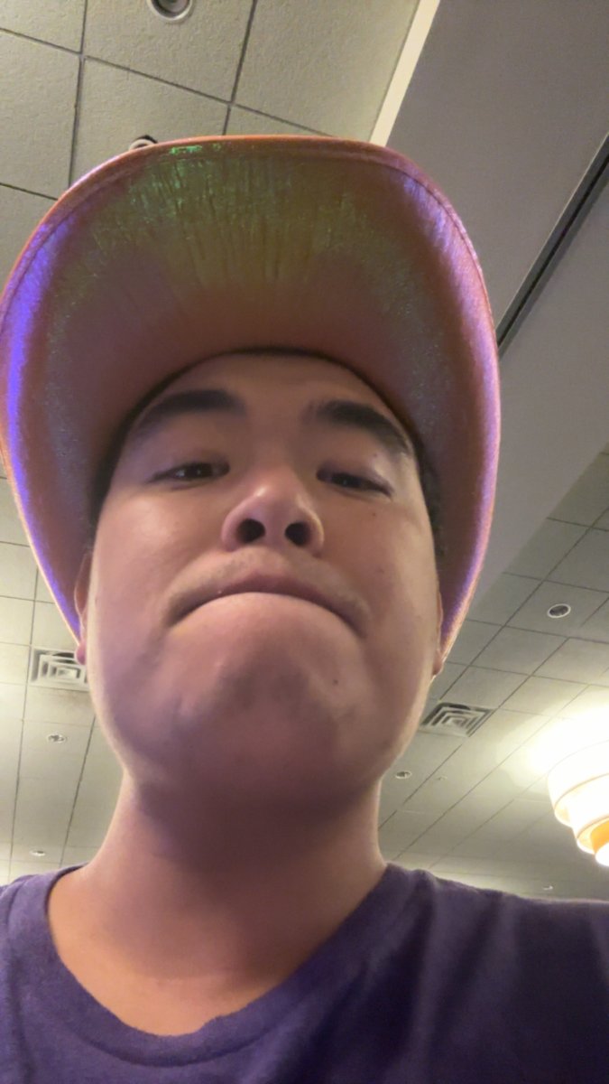 Attendee wearing a shiny hat