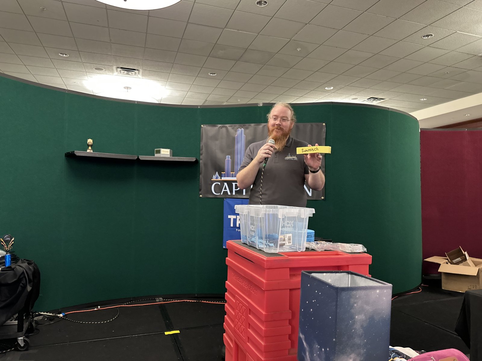 Person holding raffle ticket on stage
