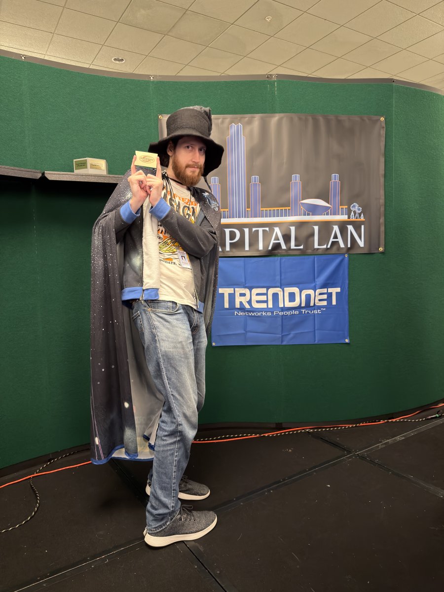 Person in wizard costume holding small box
