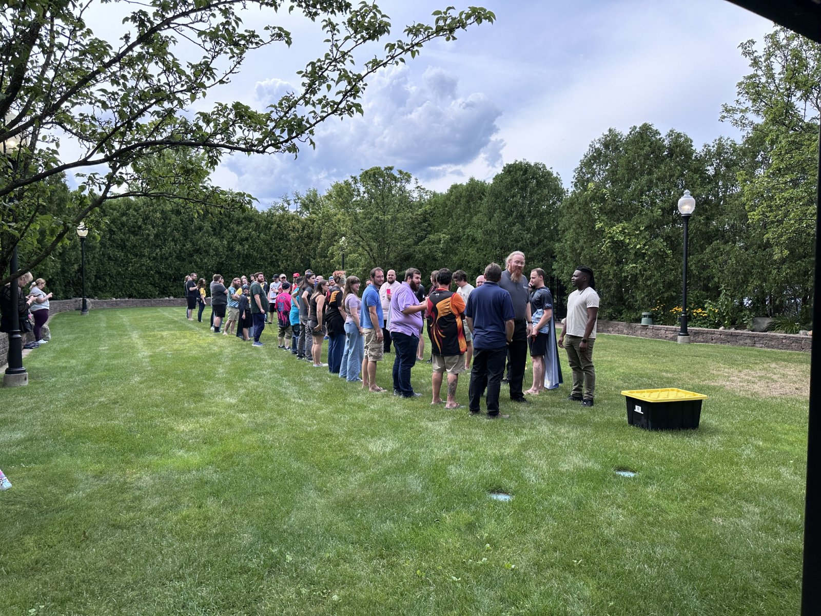Group of attendees lined up outdoors on grass