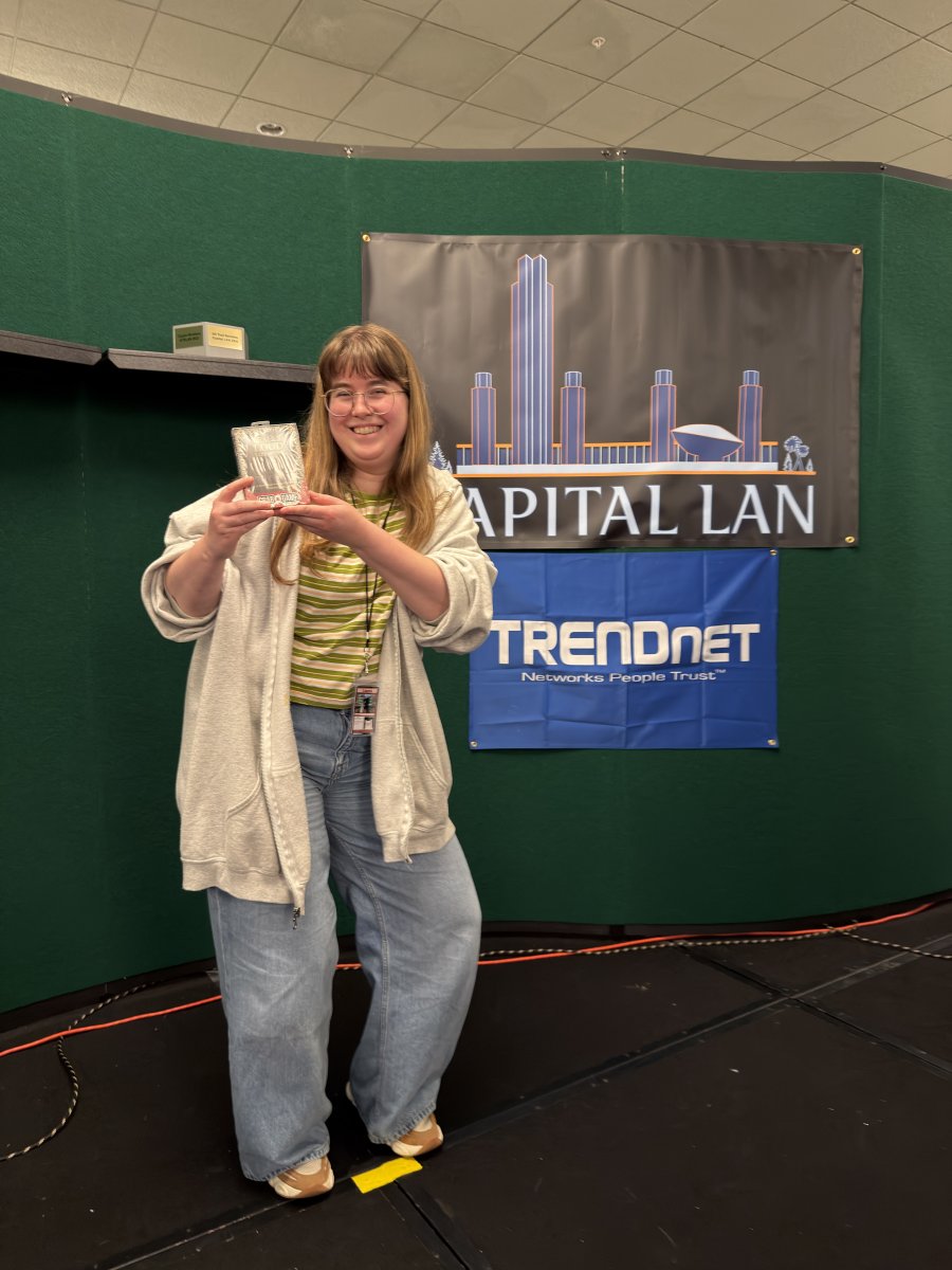Attendee holding award on stage