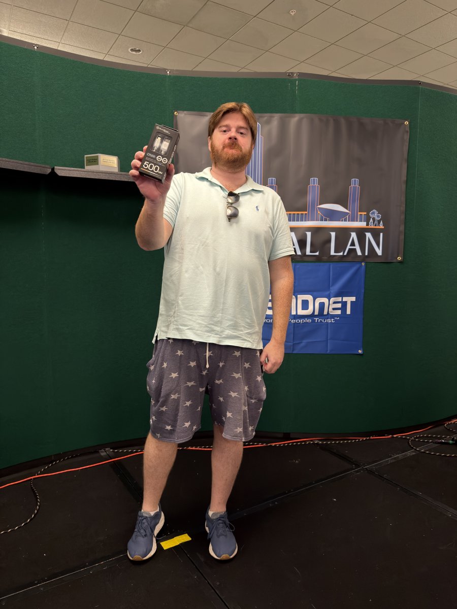 Attendee holding a prize on stage