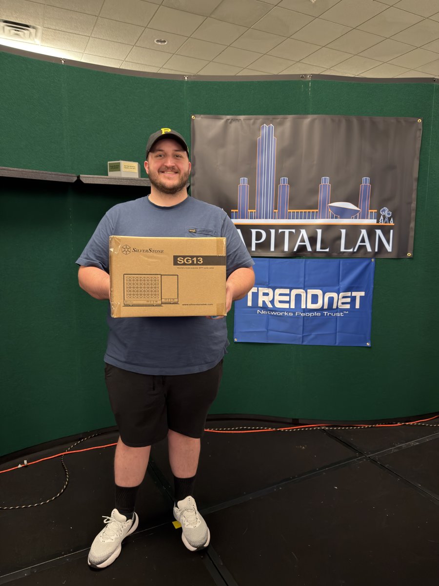 Attendee holding a boxed SilverStone SG13 computer case