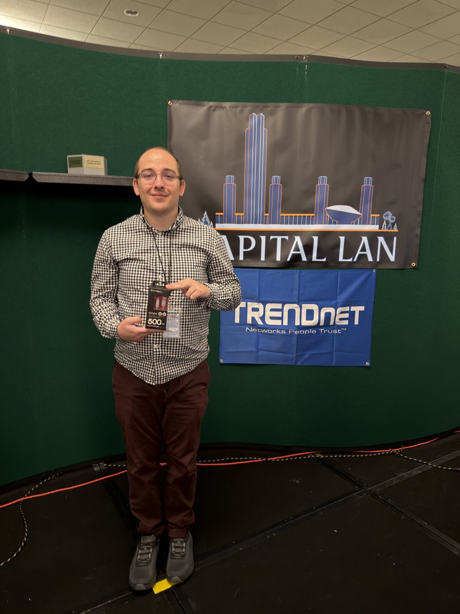 Attendee holding a prize at sponsor booth