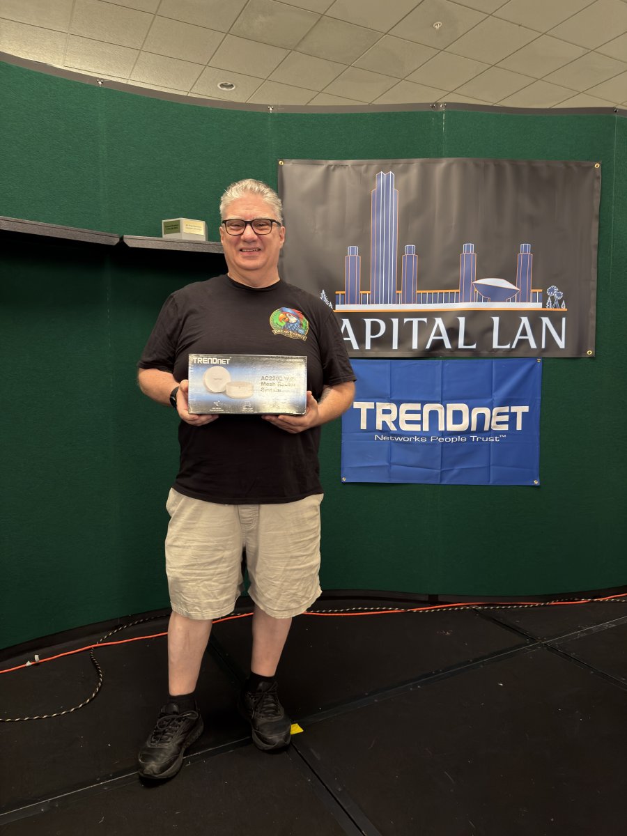 Attendee holding TRENDnet mesh router prize