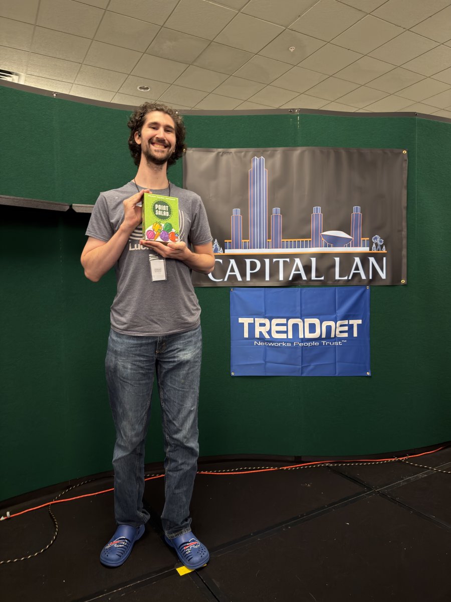 Attendee holding a Point Salad board game