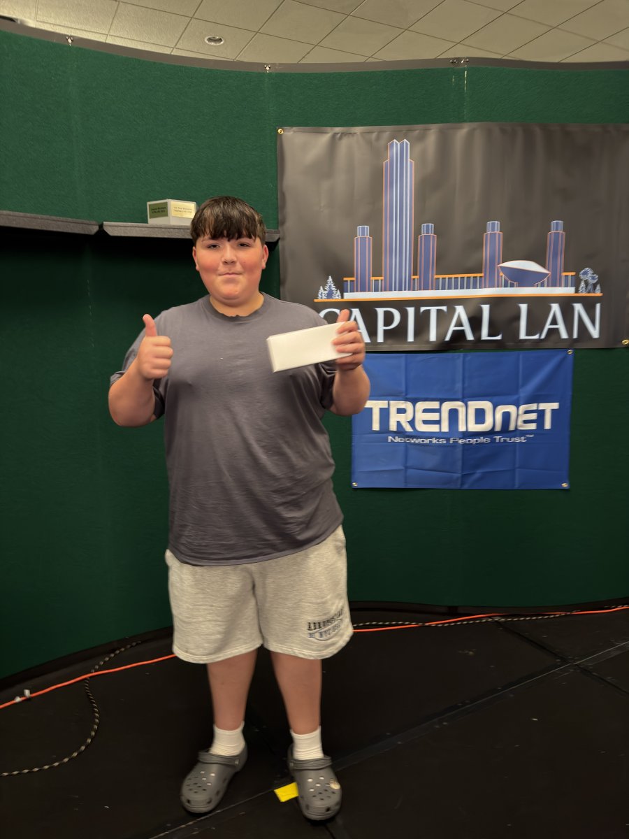 Attendee holding prize envelope on stage
