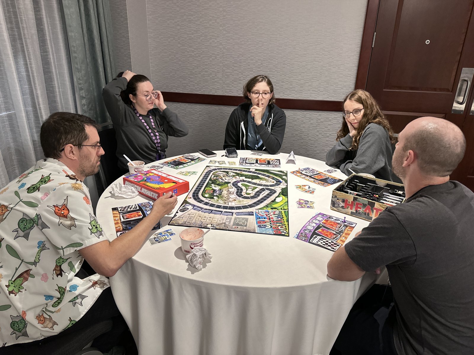 Group playing board game on round table