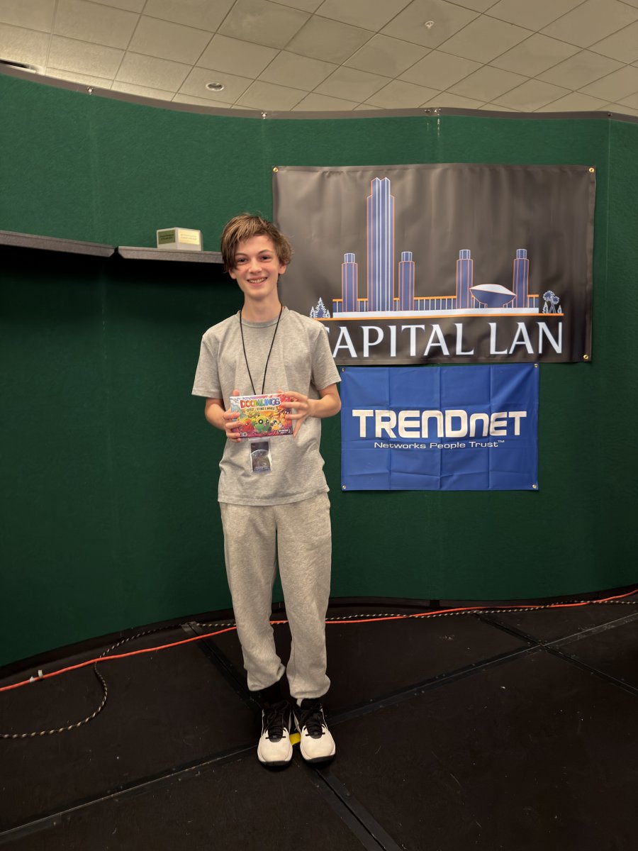 Attendee holding a prize box on stage