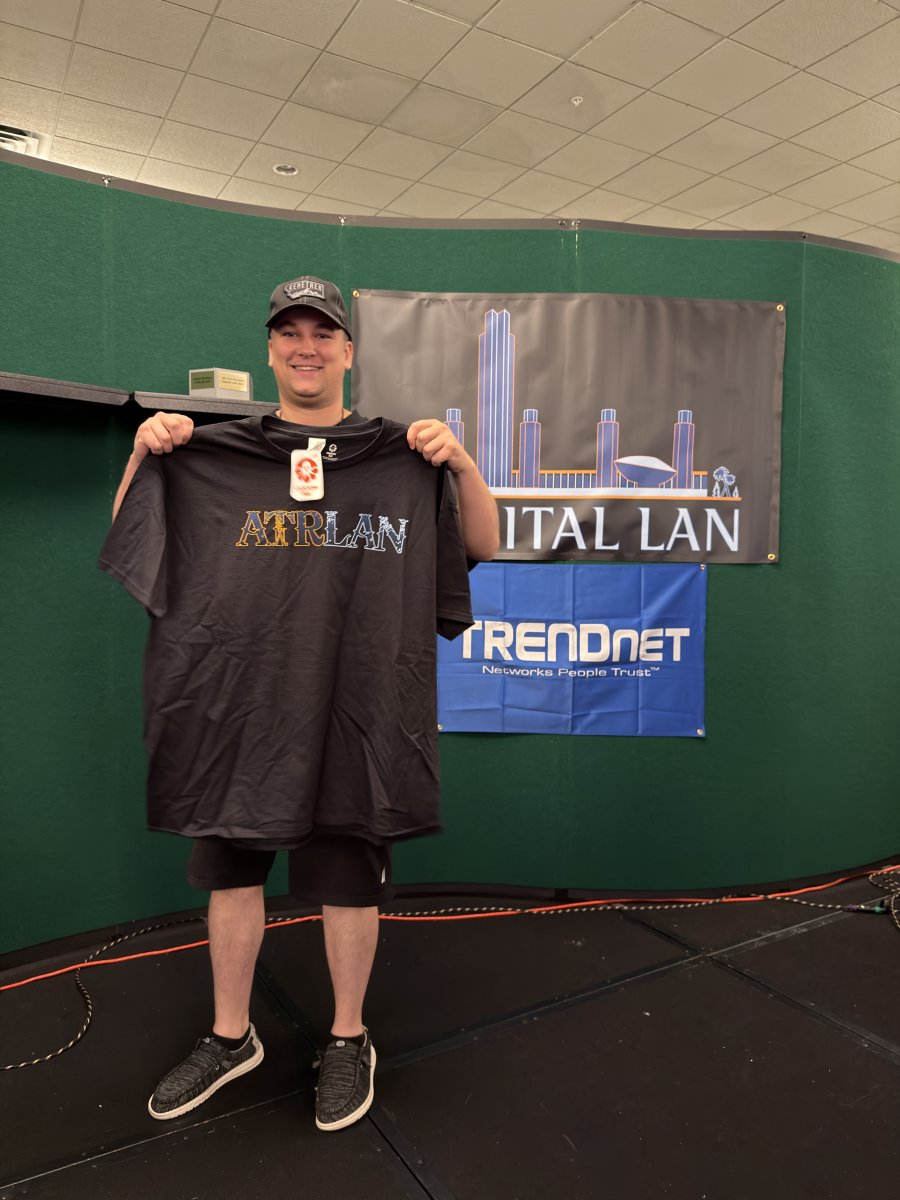 Attendee holding Capital LAN T-shirt
