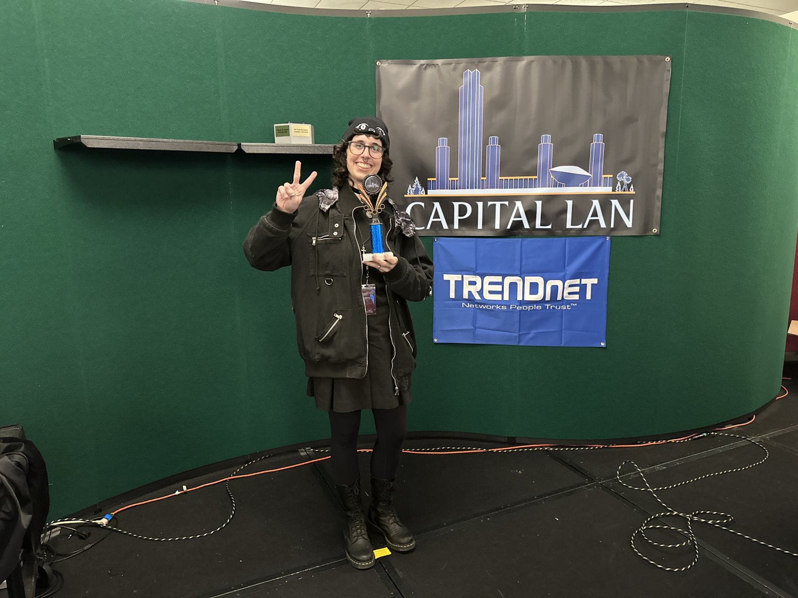 Attendee holding trophy on stage