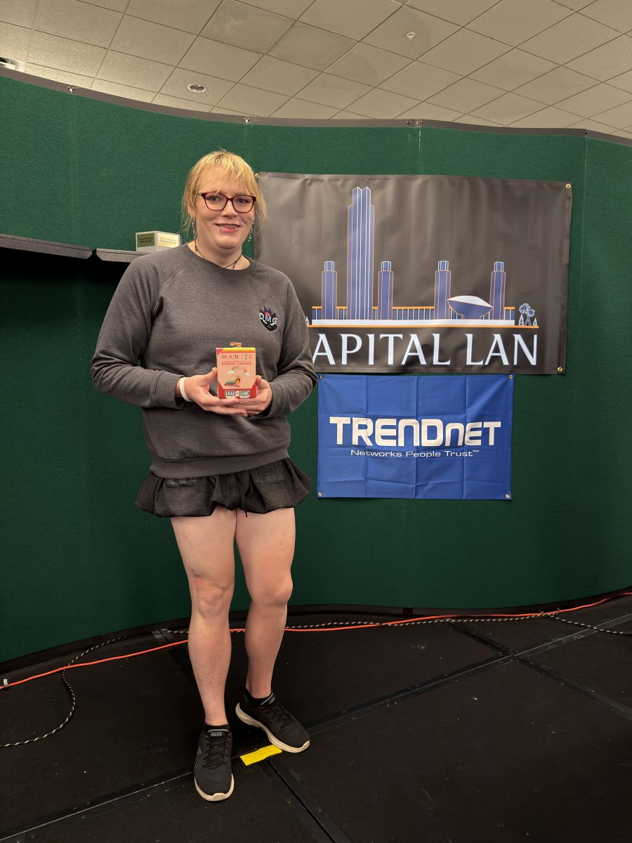 Attendee holding a boxed game on stage