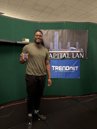 Attendee holding prize on stage