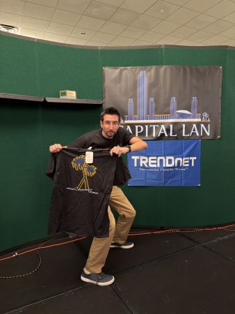 Attendee holding up a t-shirt on stage
