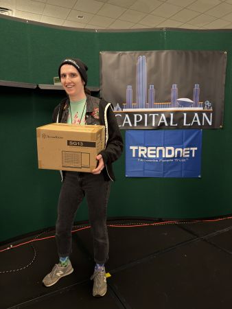 Attendee holding a boxed SilverStone SG13 computer case