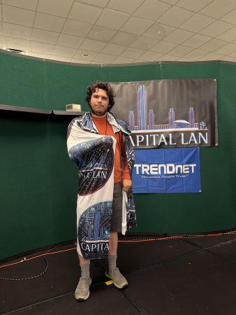 Attendee wrapped in Capital LAN blanket on stage