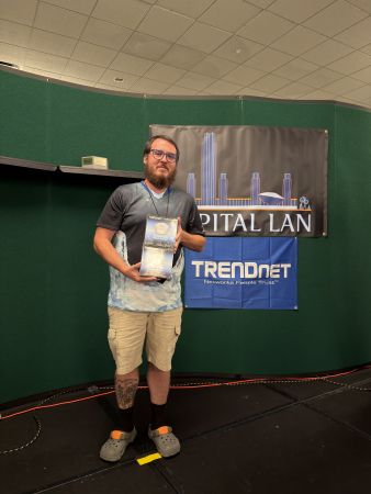 Attendee holding a prize on stage