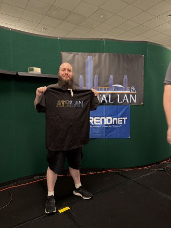 Attendee holding ATRLAN t-shirt on stage