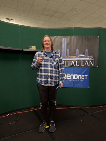 Attendee holding a small award on stage