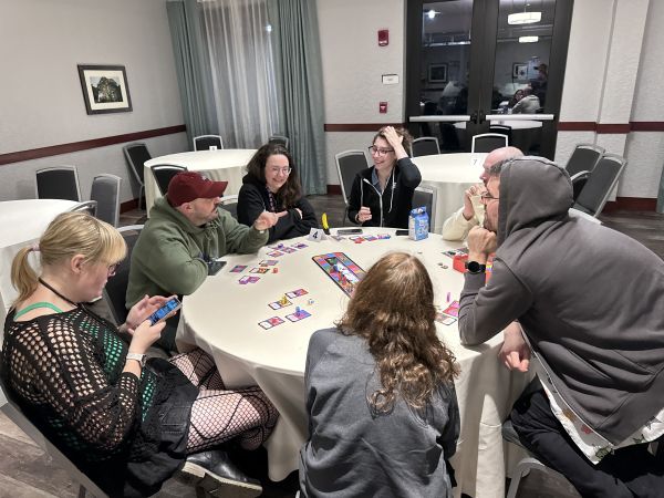 Group playing board game at round table