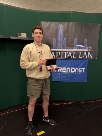 Attendee holding award box on stage