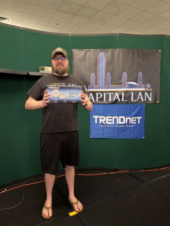 Attendee holding a TRENDnet AC2200 WiFi Mesh Router prize