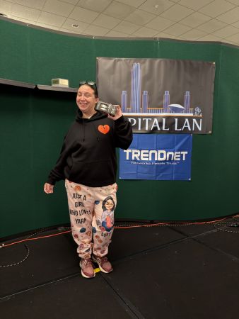 Attendee holding prize on stage