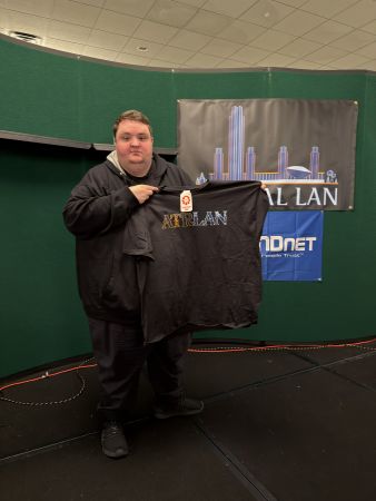 Attendee holding Capital LAN T-shirt