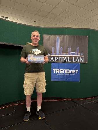 Attendee holding TRENDnet AC2200 WiFi Mesh Router prize
