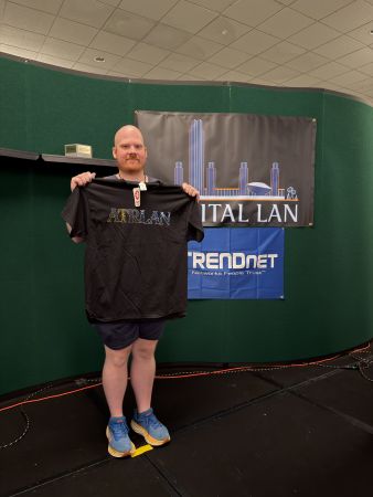 Attendee holding Capital LAN t-shirt
