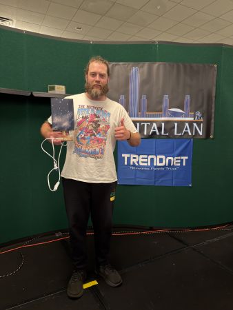 Attendee holding a trophy on stage