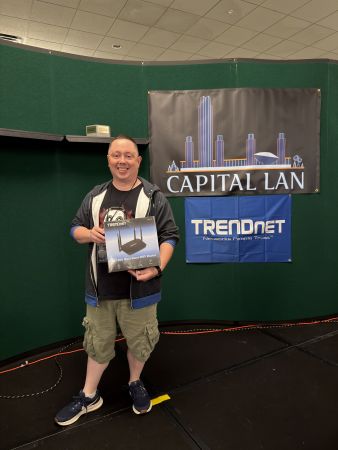 Attendee holding TRENDnet WiFi router prize