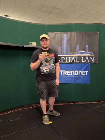Attendee holding a prize card on stage
